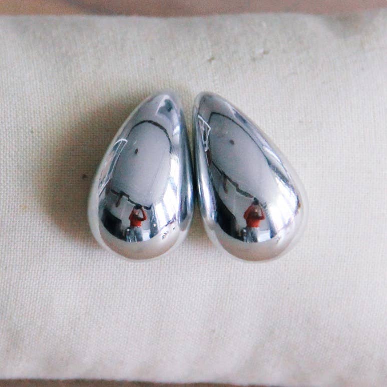 Two teardrop shaped stainless steel earrings.