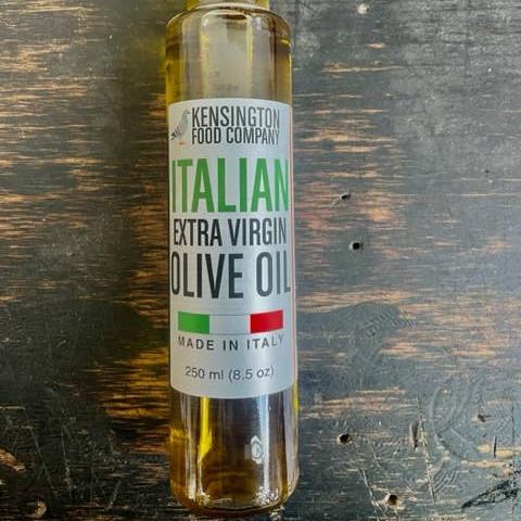 A tall skinny glass bottle of italian Extra Virgin Olive Oil.