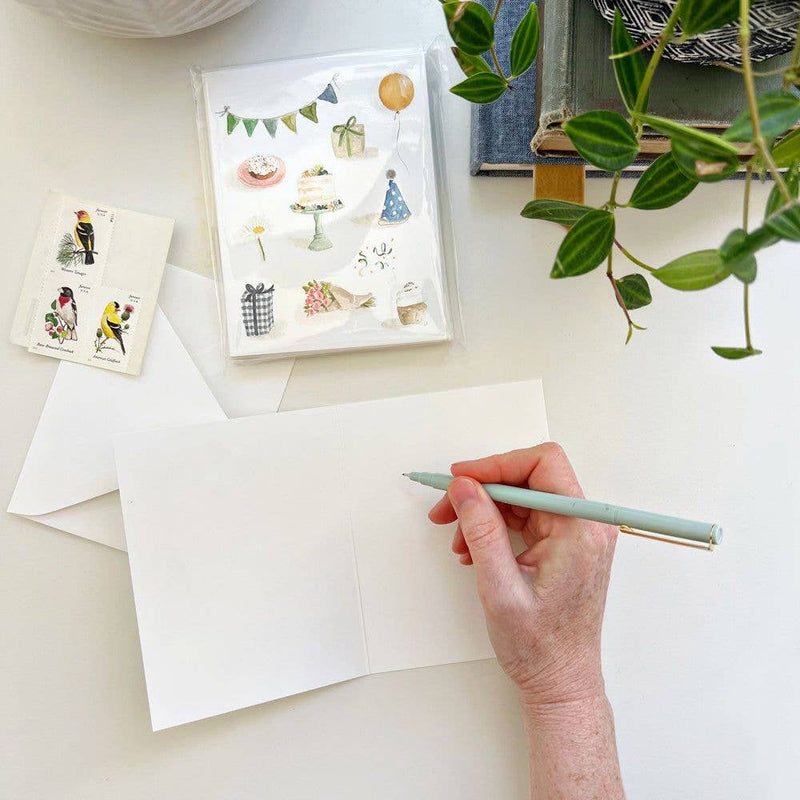 A person about to write a message inside the Celebrate Notecard.