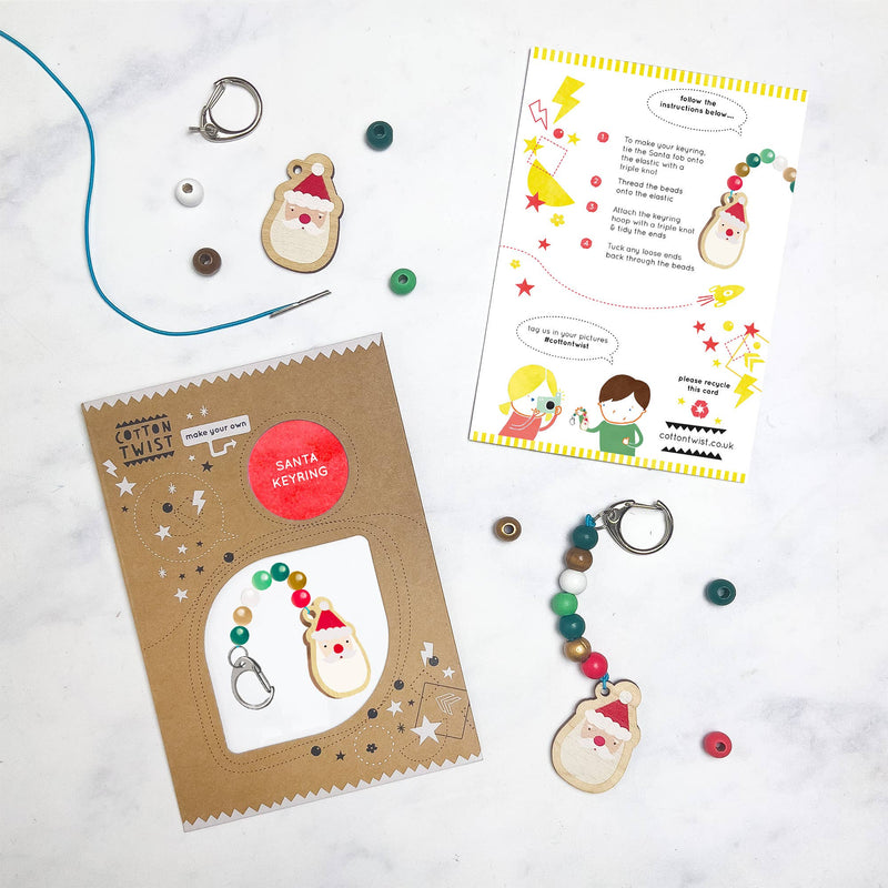 A kit with wooden beads, key chain materials, and a wooden santa.