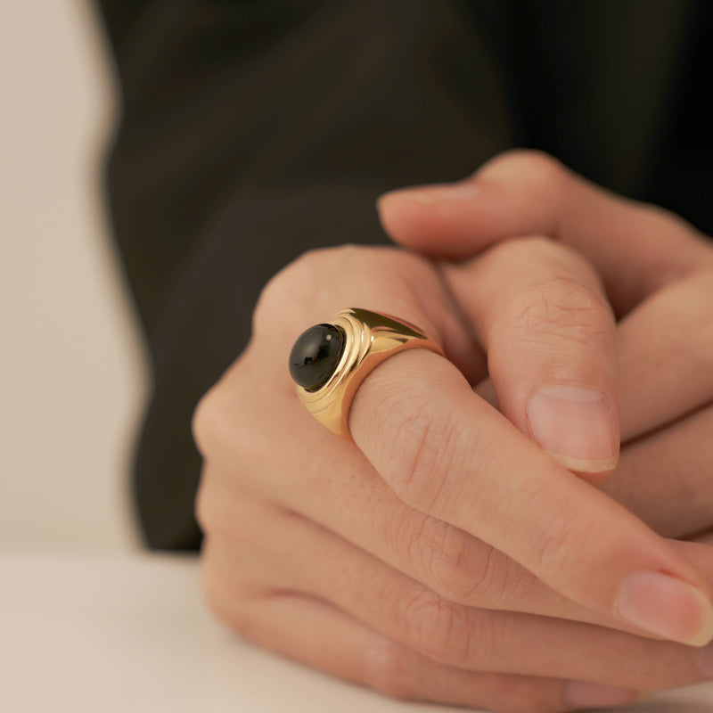 A person wearing the Onyx Square Signet Ring.