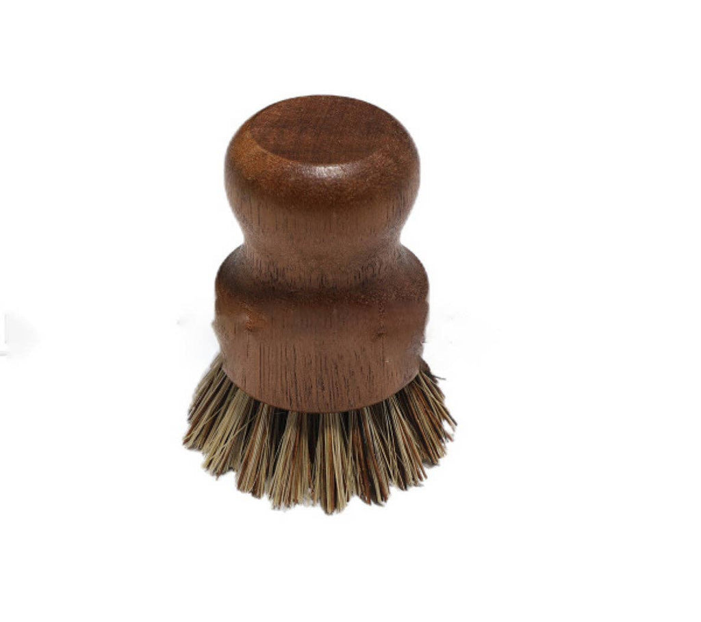 A small dark wooden dishwashing brush with dark bristles.