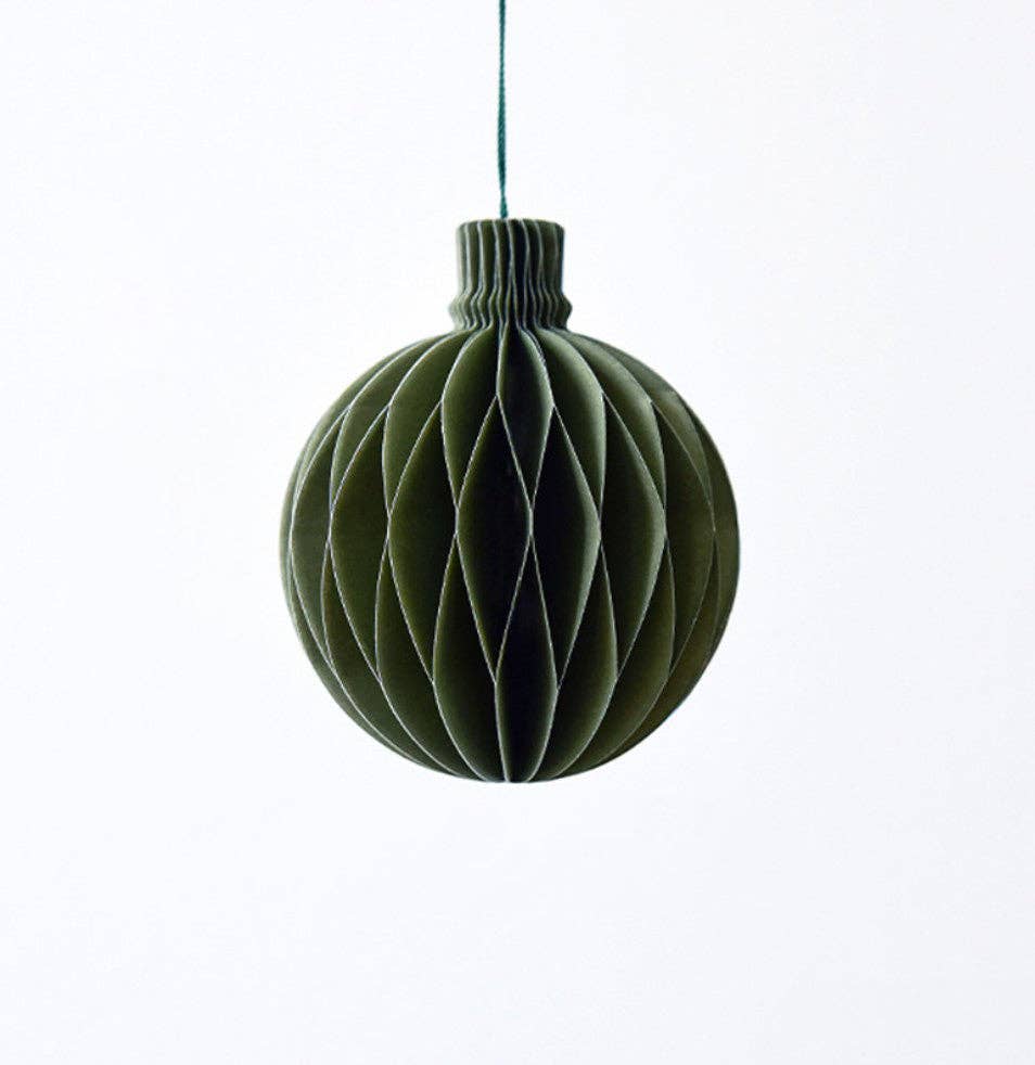 An evergreen circular paper ornament.