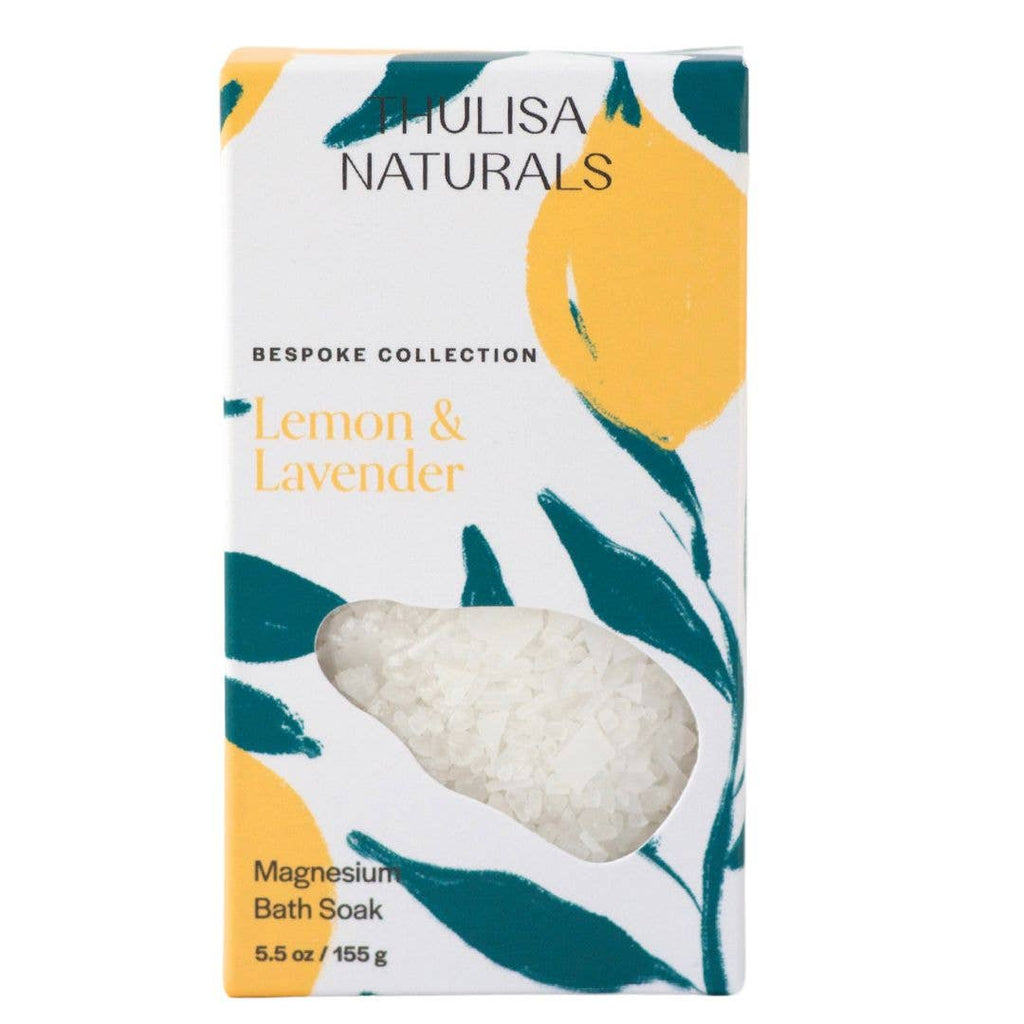 A white box illustrated with lemons and botanicals filled with lemon and lavender scented magnesium salt flakes.