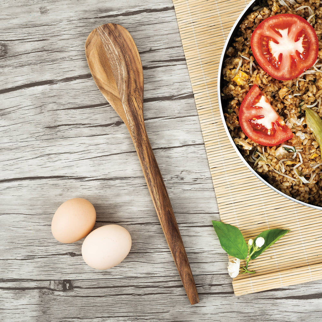 An Acacia Wood Spoon next to a pair of eggs and a rice dish.