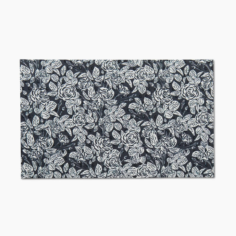 A black Not Paper Towel patterned with white roses.