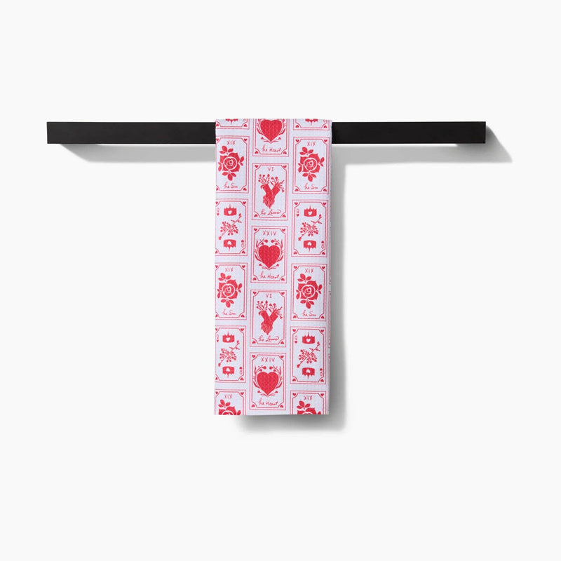 The Lovers Tea Towel hanging from a towel rack.