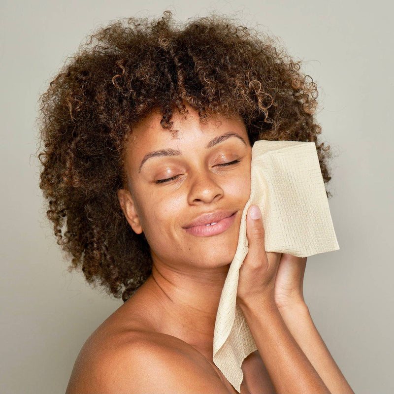 A person smiling while using the Bamboo Clean Towels XL.