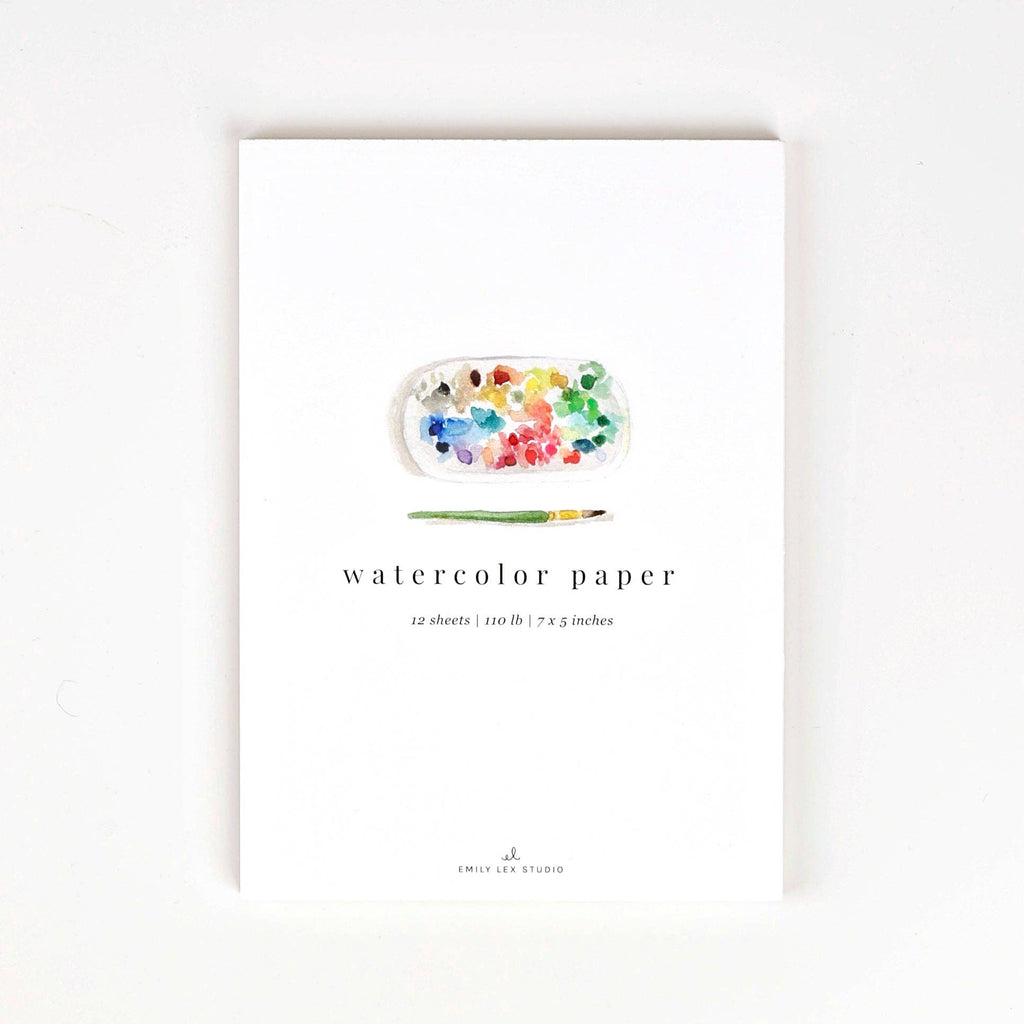 A white Watercolor Paper pad with a watercolor illustration of a paint palette and brush.