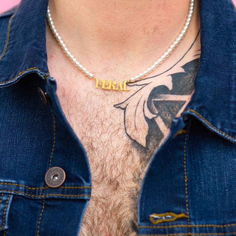 A person wearing the Feral Necklace with a denim jacket.