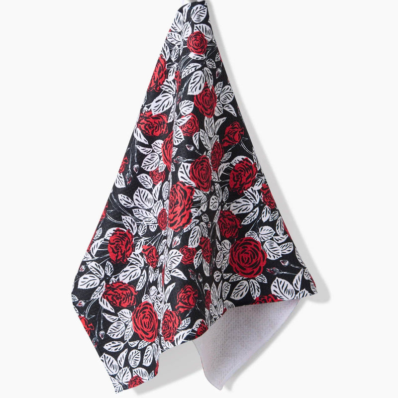 A Love and Roses Tea Towel hanging from a hook.