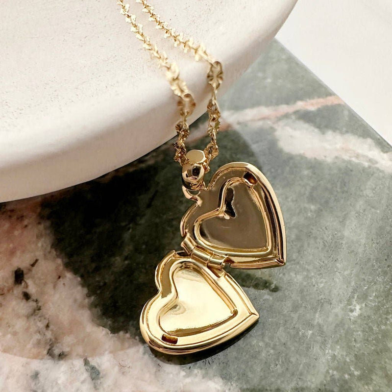 An open Golden Heart Locket necklace.