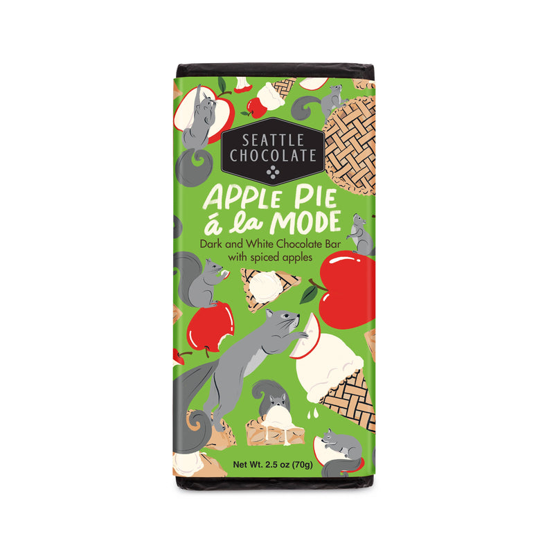 A chocolate bar covered in black foil and a green bellyband with illustrations of apples, ice cream, and squirrels.