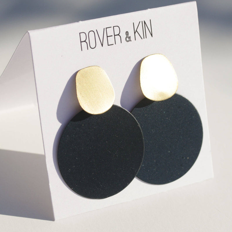 The Ultramarine Eclipse Earrings on its paper packaging.