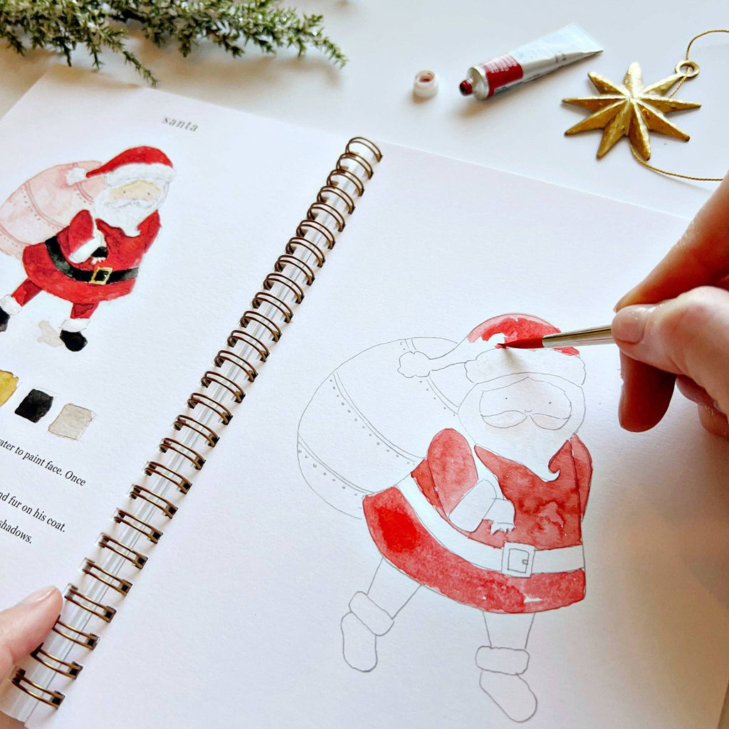 A person watercolor painting a Santa Claus.