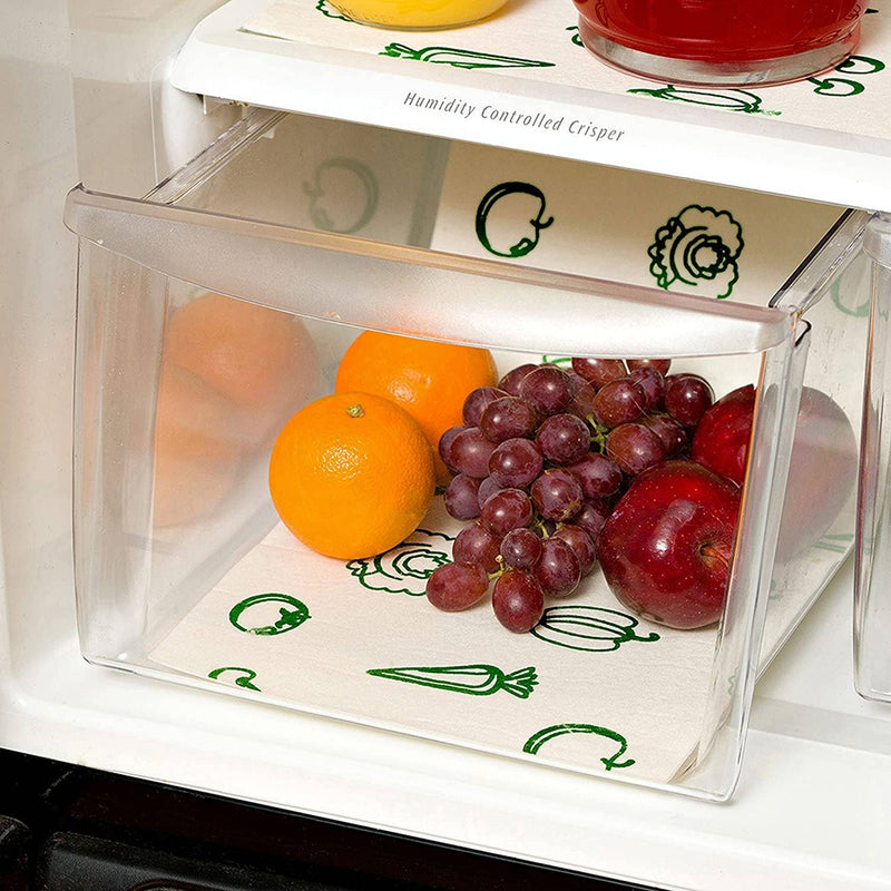 A fridge bin lined with the liner and filled with oranges, grapes, and apples.