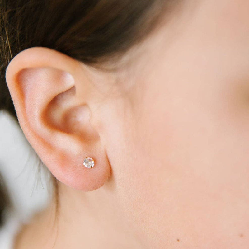 A close-up of someone wearing the Diamond Stud Earring in their right ear.