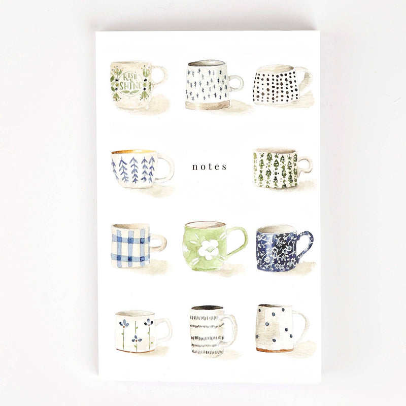 A notebook illustrated with a variety of watercolor mugs around the word "notes".