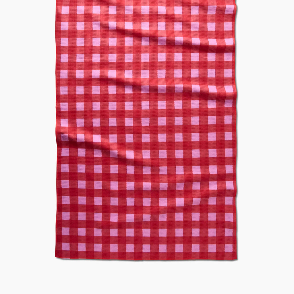 A red and pink gingham plaid bath towel.