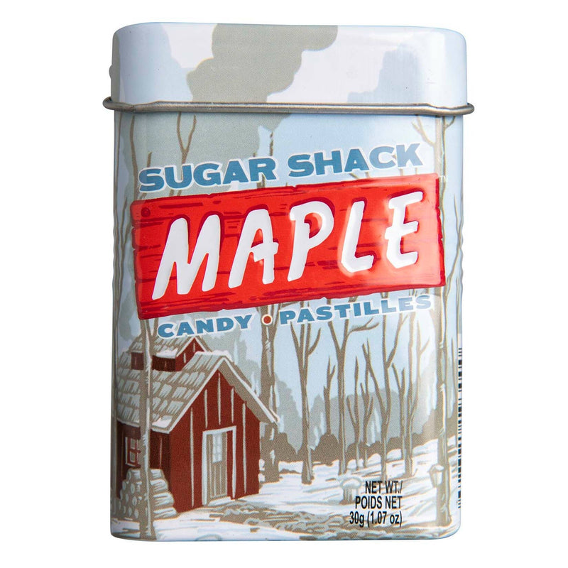 A pale blue tin of Sugar Shack Maple Candies illustrated with a red cabin in a wintery wood.