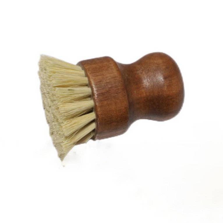 A small dark wooden dishwashing brush with light bristles on its side.