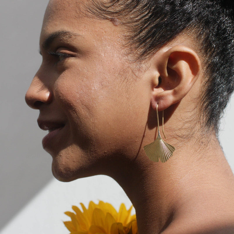 A person wearing the Gingko Leaf Earrings.