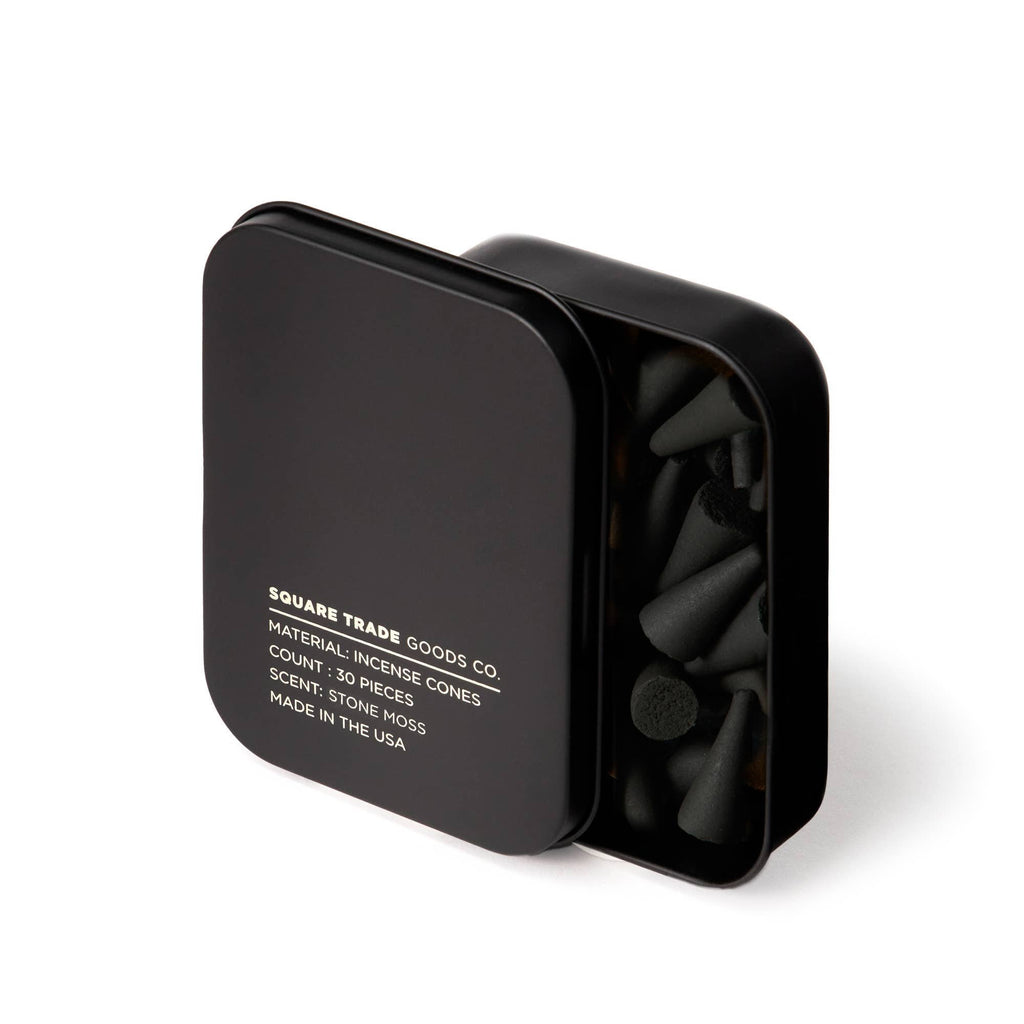 A matte black square tin filled with black Stone Moss Incense Cones.