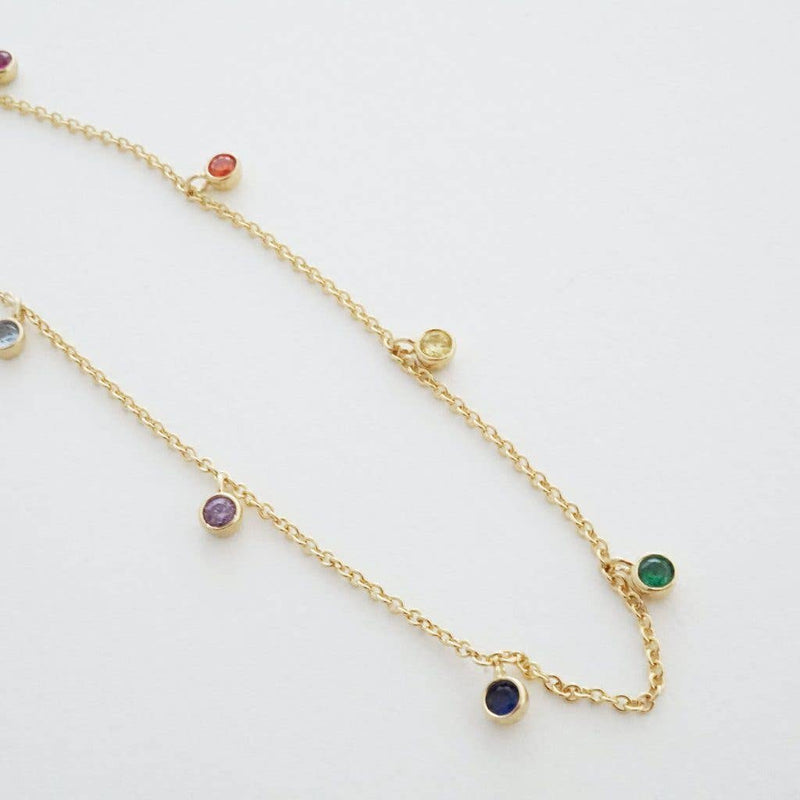 A close-up of the purple, blue, green yellow, and orange crystals hanging from the chain.