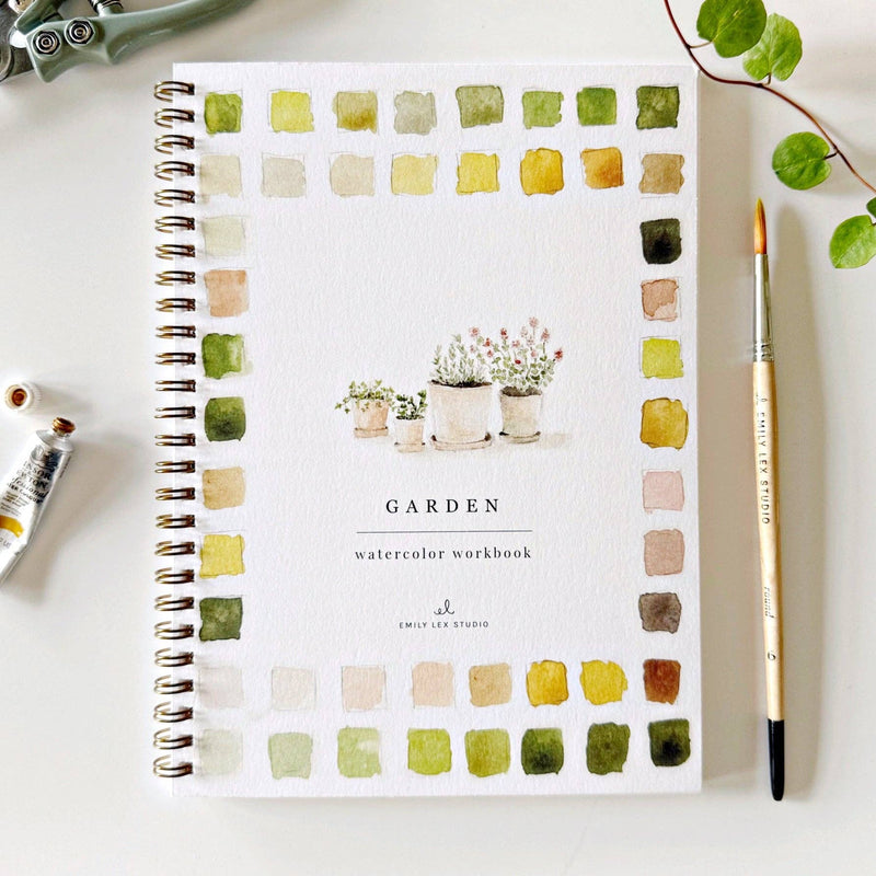 The cover for a spiral watercolor workbook themed around the garden with watercolor swatches in yellows, greens, and browns.