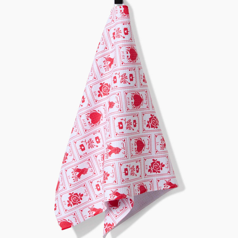 The Lovers Tea Towel hanging from a hook.