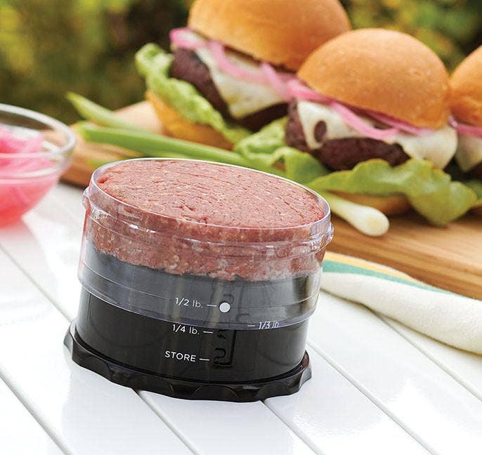 A burger being formed in the burger press.