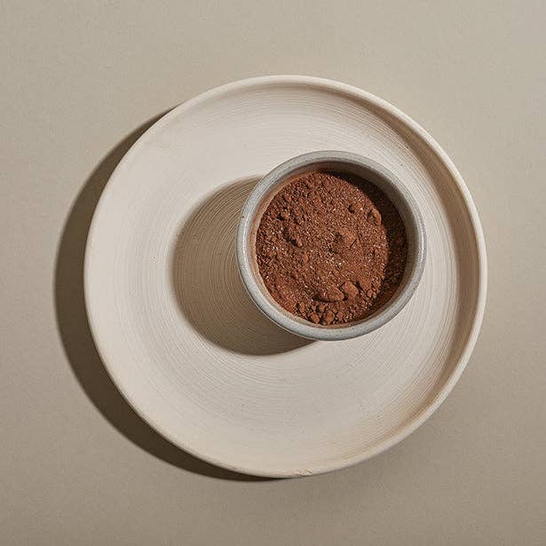 A ceramic bowl filled with hot chocolate mix.