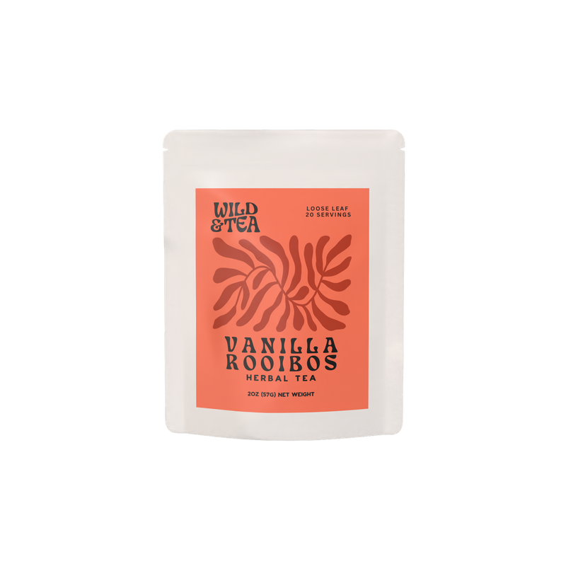 A white bag filled with Vanilla Rooibos herbal tea with an orange red label illustrated with an abstract plant.