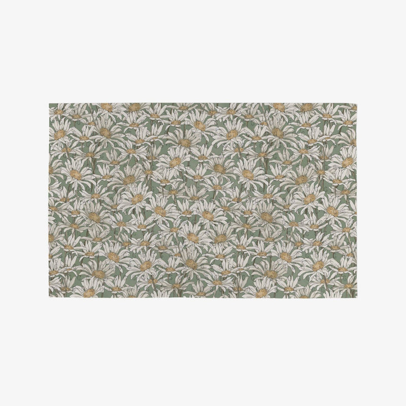 A pale green Not Paper Towel patterned with crowded white and yellow daisies.