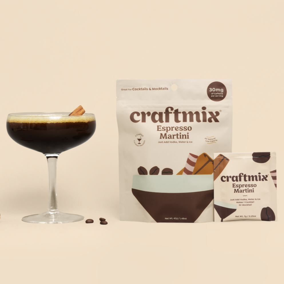 An espresso martini in a martini glass next to a cream pouch of Craftmix Espresso Martini Mixes.