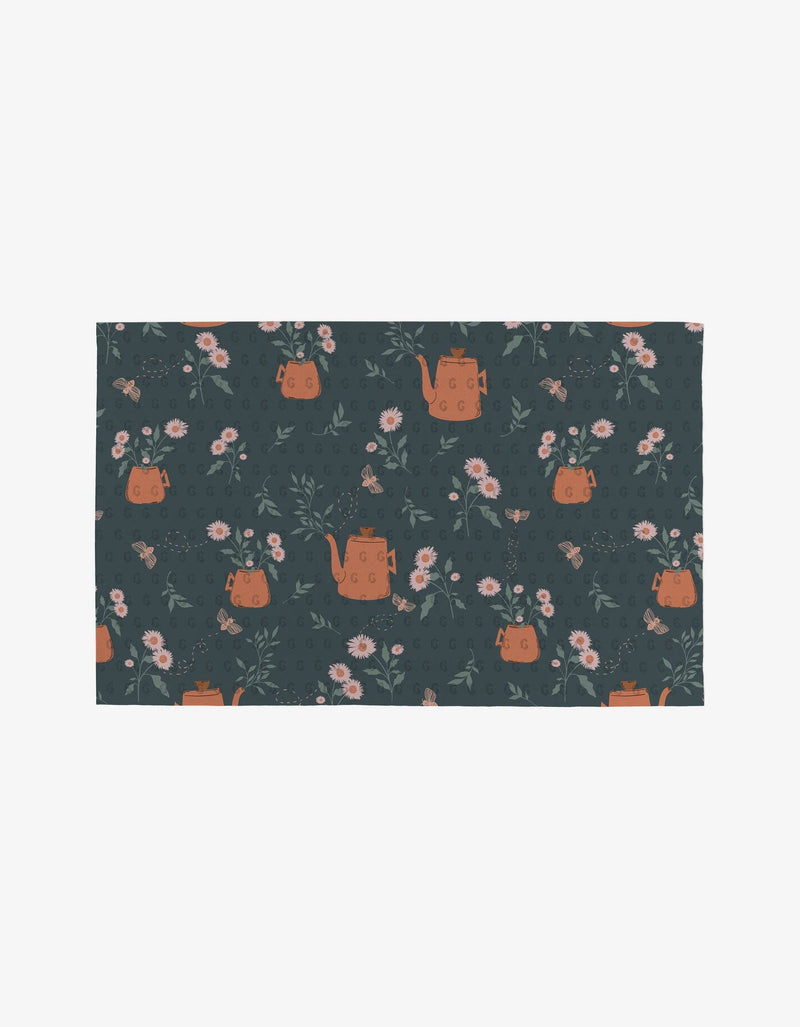 A spruce green Not Paper Towel printed with flower vases and orange watering cans.