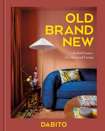 A light red book cover with a photo of a modern designed living room and the words "Old Brand New: Colorful Homes for Maximal Living by Dabito" in yellow.