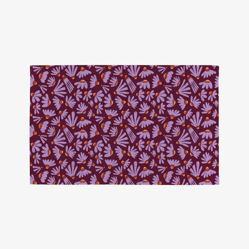 A burgundy Not Paper Towel printed with purple petaled flowers.