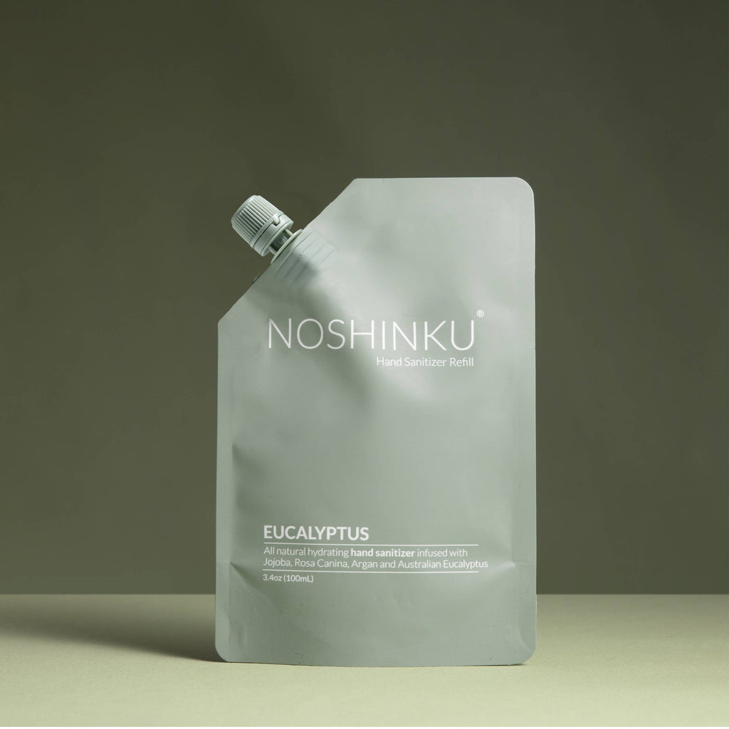 A matte pale green pouch labelled and  filled with Noshinku Hand Sanitizer Refill in Eucalyptus.