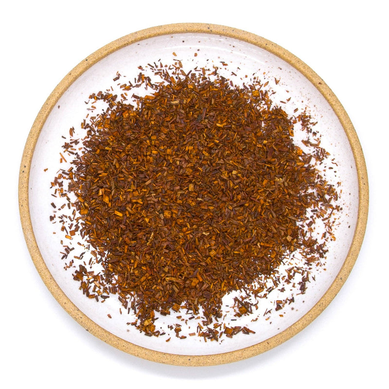 A ceramic plate filled with red rooibos.