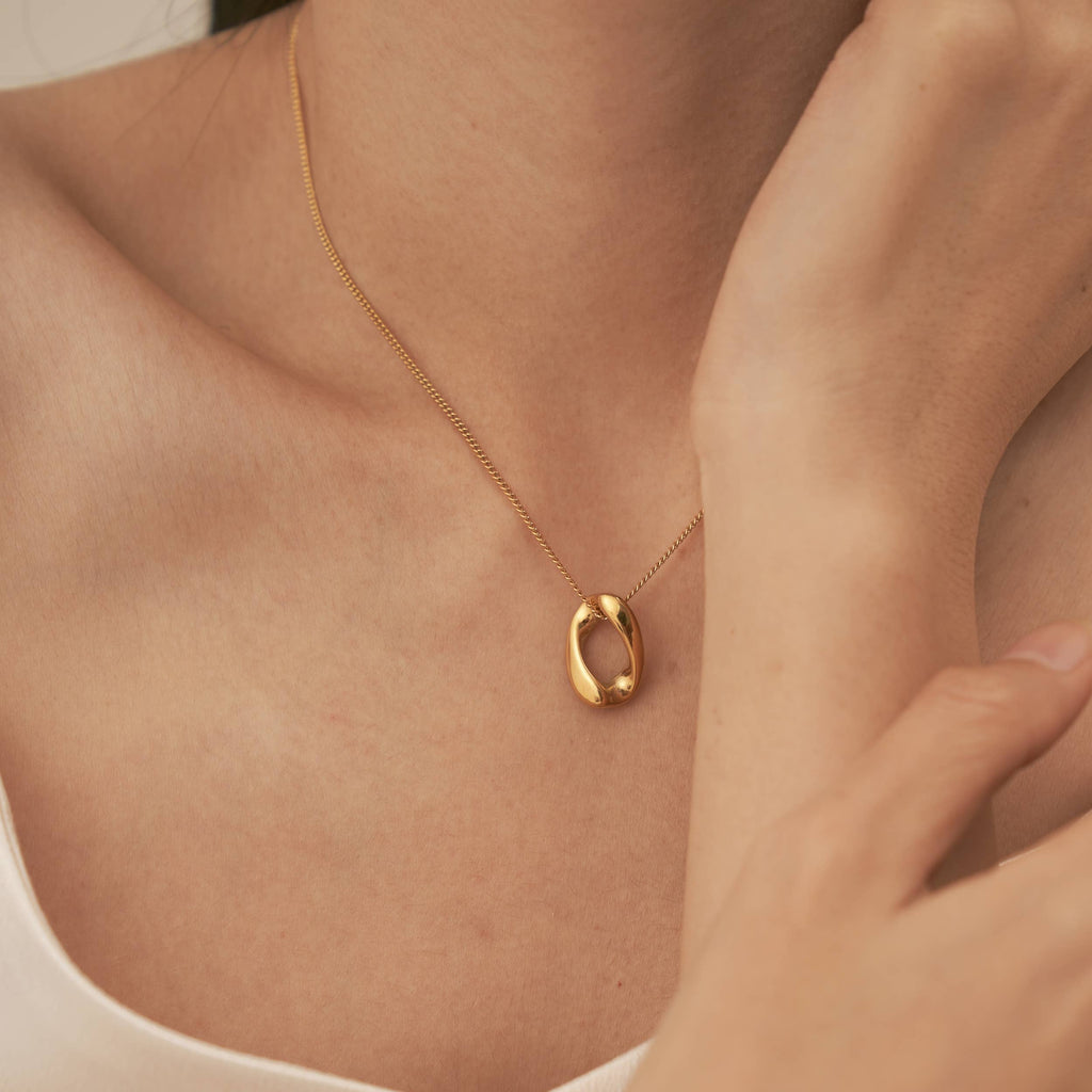 A person wearing the Infinity Loop Necklace.