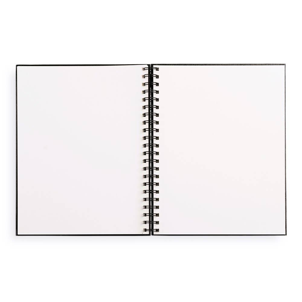 An open sketchbook with blank white pages and lines to tear away pages along the spine.