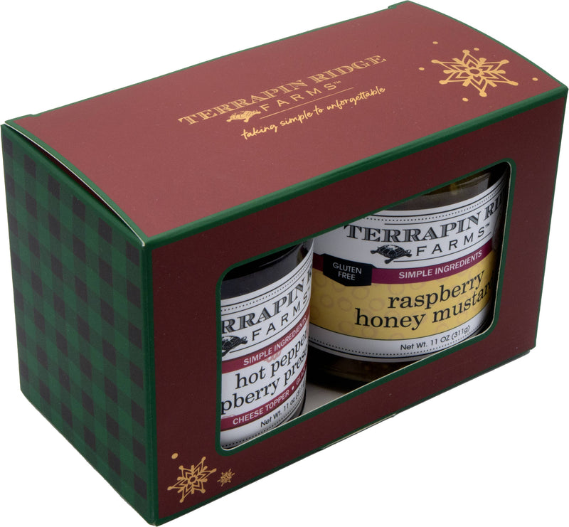 A red and green gift box holding Hot Pepper Raspberry Preserves and Raspberry Honey Mustard.