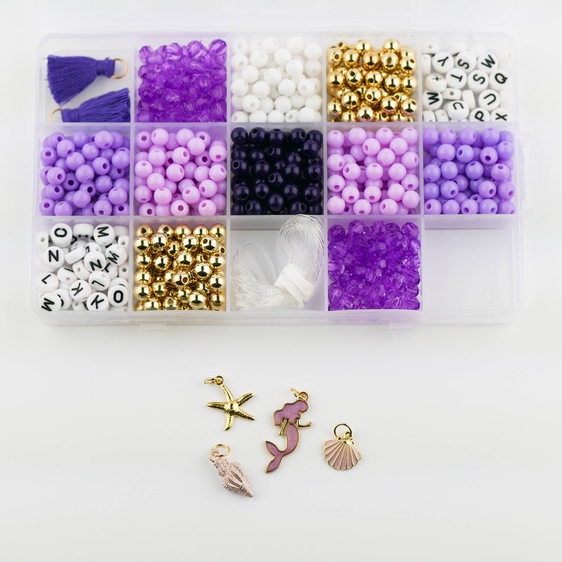 A starfish charm, a purple mermaid charm, and two seashell charms below a storage box filled with beads and tassels.