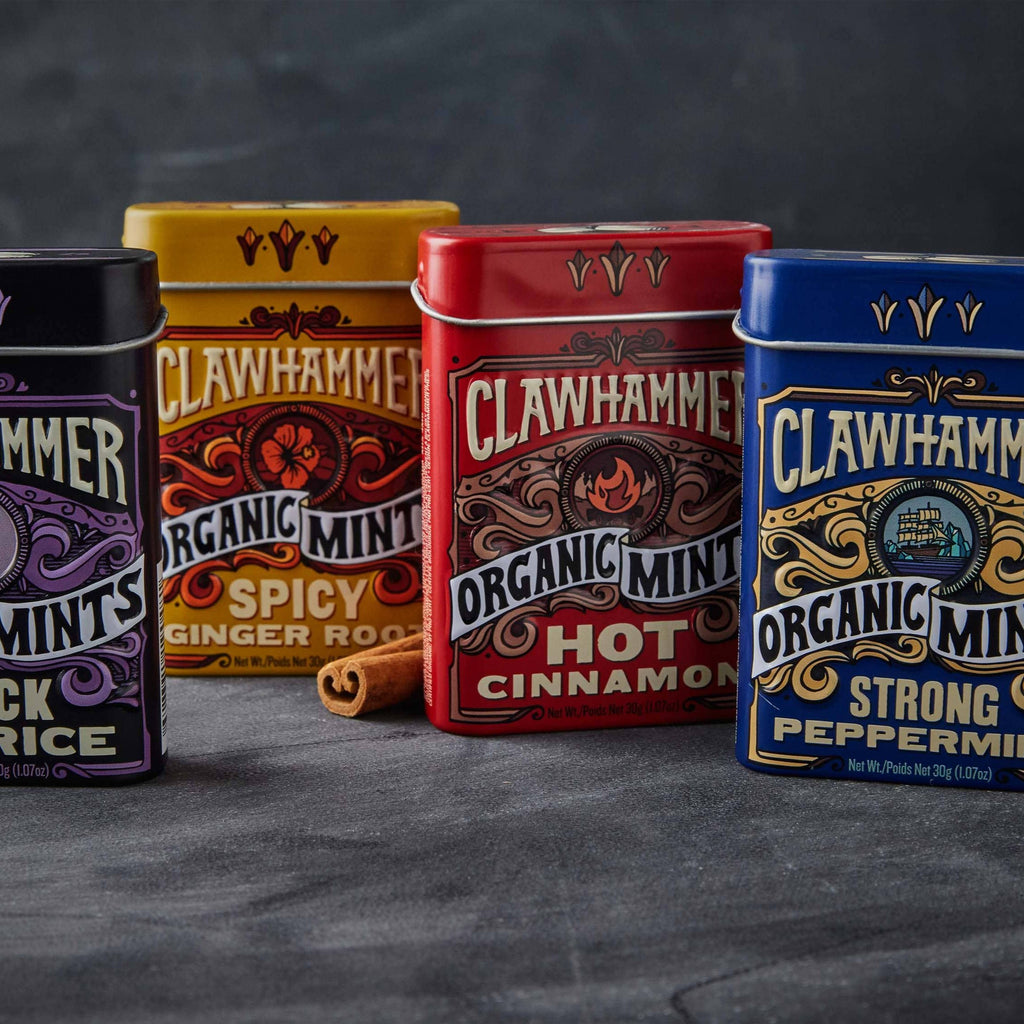 Four tins of Clawhammer Organic Mints in four different colors and flavors.