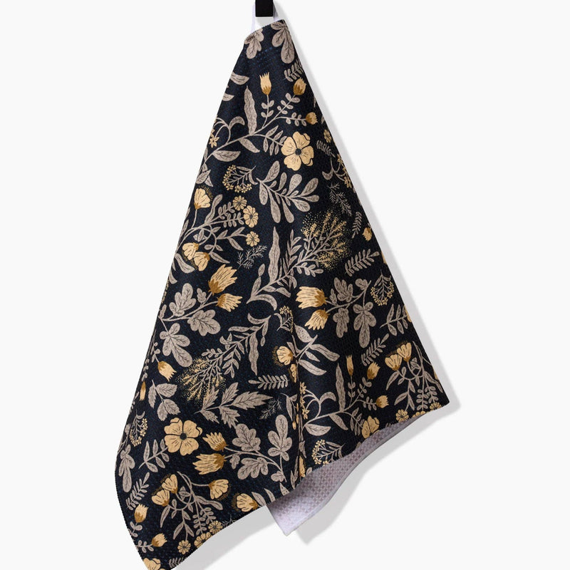 A Woodland Wildflowers Tea Towel hanging from a hook.