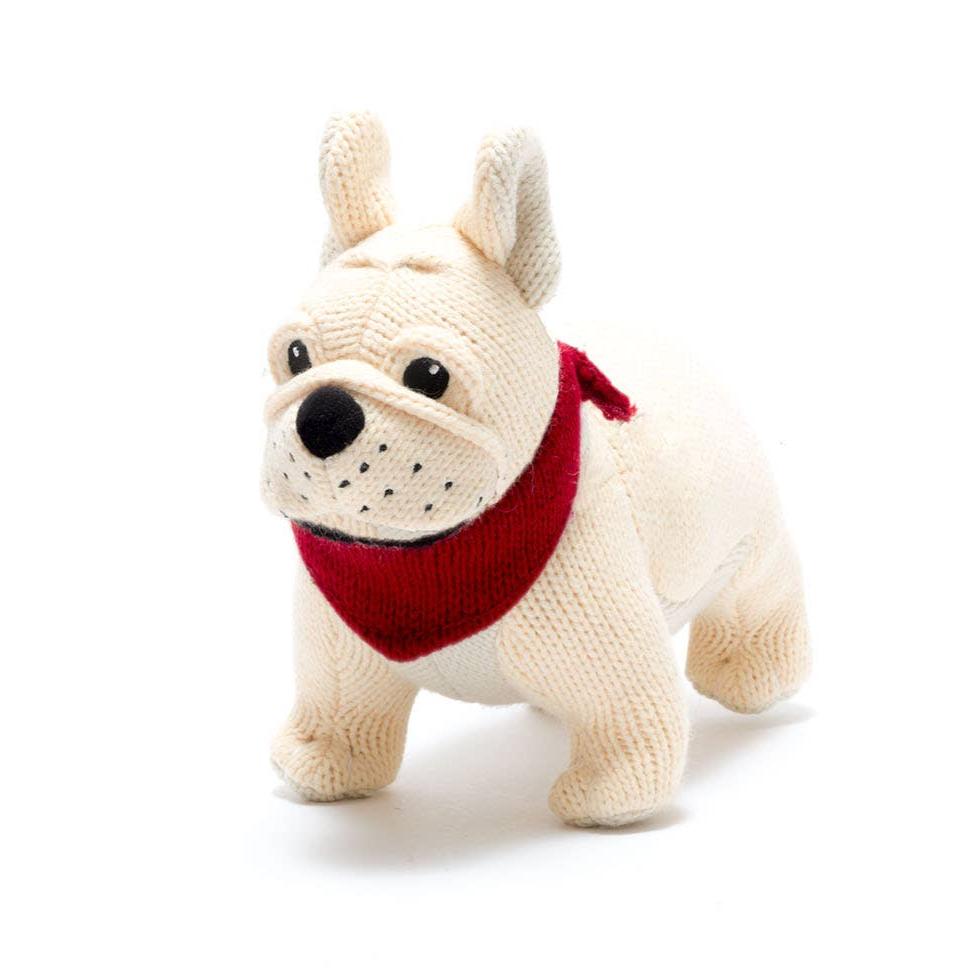 A cream colored knitted bulldog plush toy with a red knitted bandana.