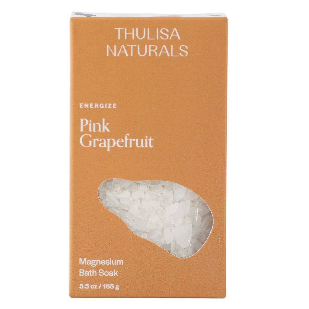 An orange box filled with pink grapefruit scented magnesium salt flakes