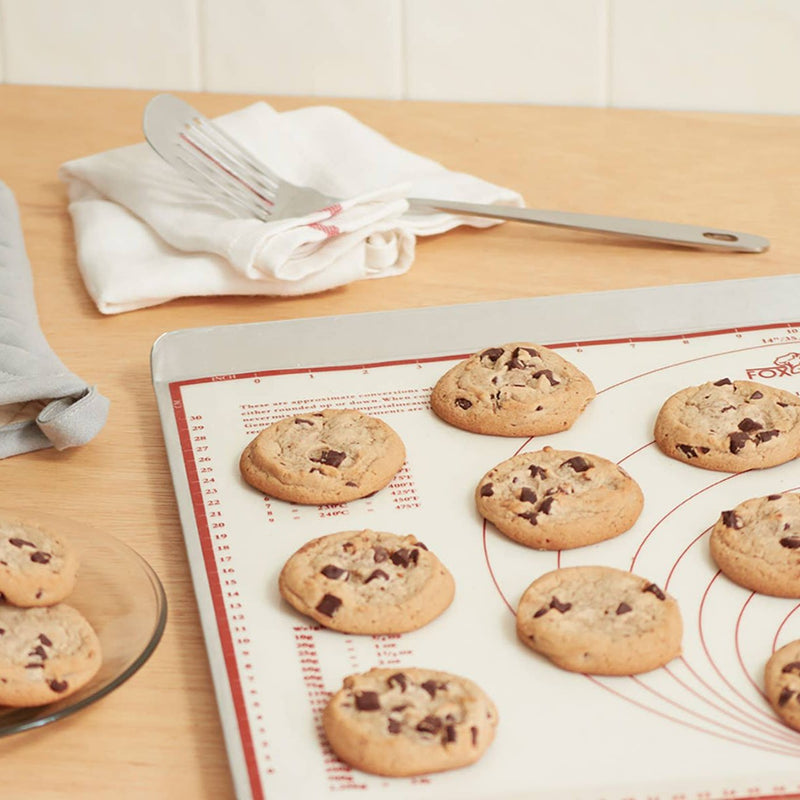 Freshly baked cookies cooling on the baking mat.