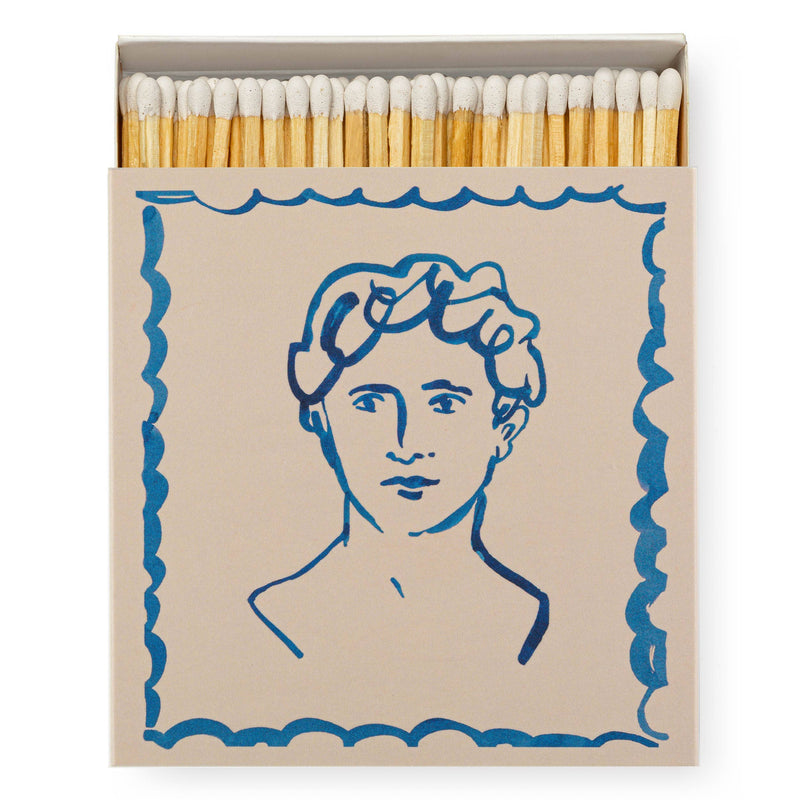 A square matchbox illustrated with a lineart portrait of a man's face.